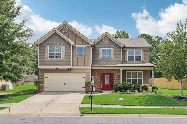 a front view of a house with a yard