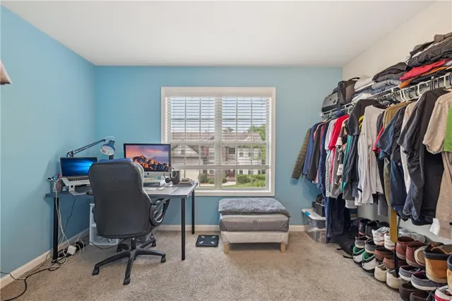 a view of a workspace with furniture and a window