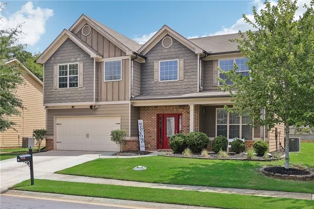 a front view of a house with a yard