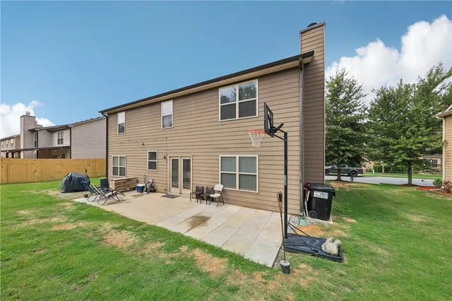 a backyard of a house with table and chairs
