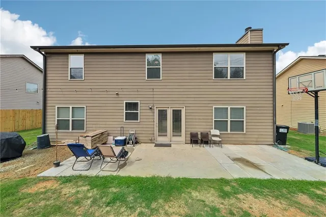 a backyard of a house with table and chairs