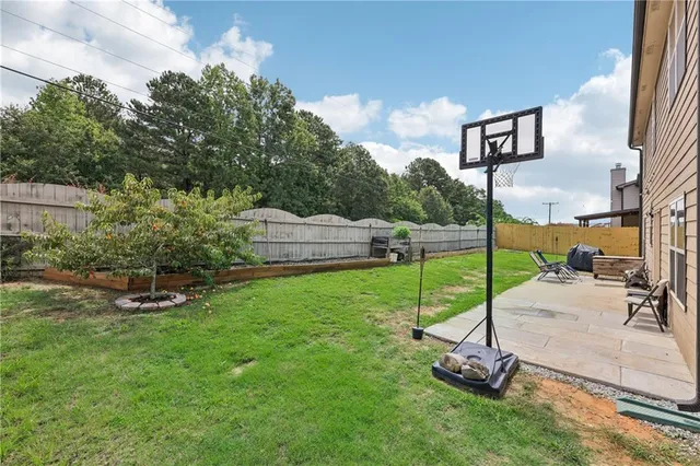 a view of a backyard with sitting area and slide