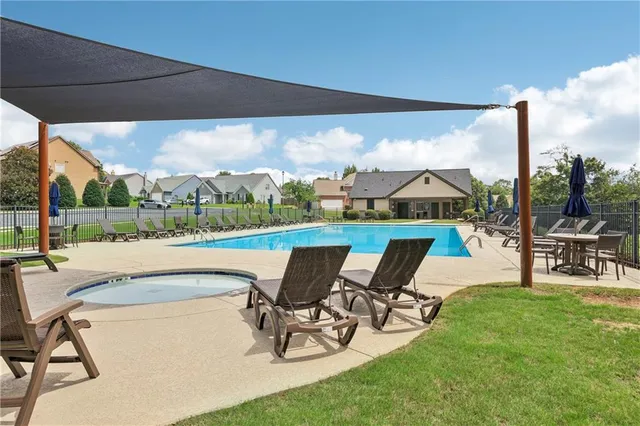 a view of a swimming pool with chairs in patio