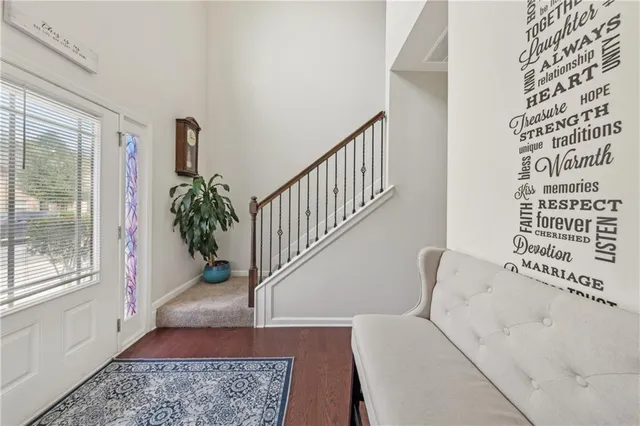 a view of entryway with a window and wooden floor