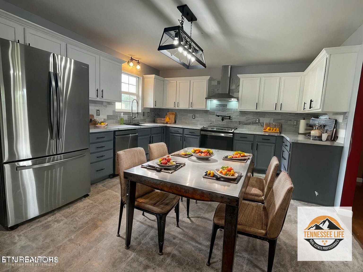 5409 Old Niles Ferry Road Maryville, TN 37801 - Photo 11 of 43 a kitchen with stainless steel appliances granite countertop a dining table chairs refrigerator and microwave