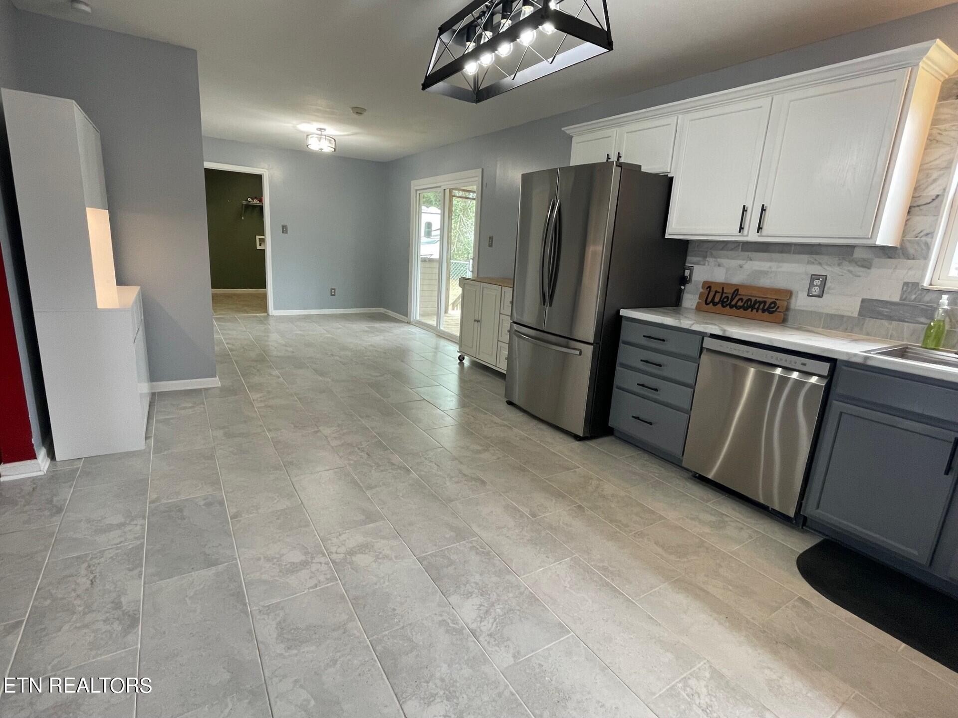 5409 Old Niles Ferry Road Maryville, TN 37801 - Photo 13 of 43 a kitchen with stainless steel appliances a refrigerator a sink a stove a microwave and island