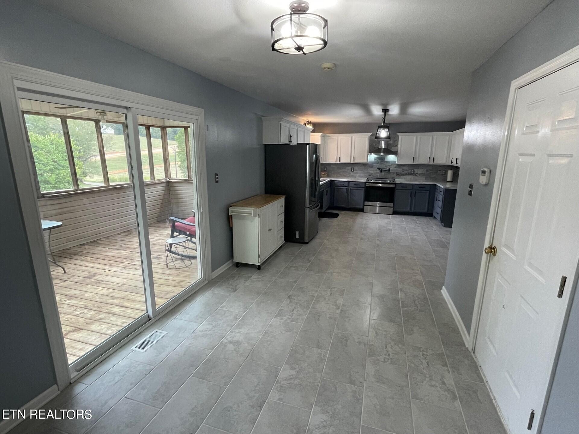5409 Old Niles Ferry Road Maryville, TN 37801 - Photo 15 of 43 a view of a livingroom with kitchen and chandelier