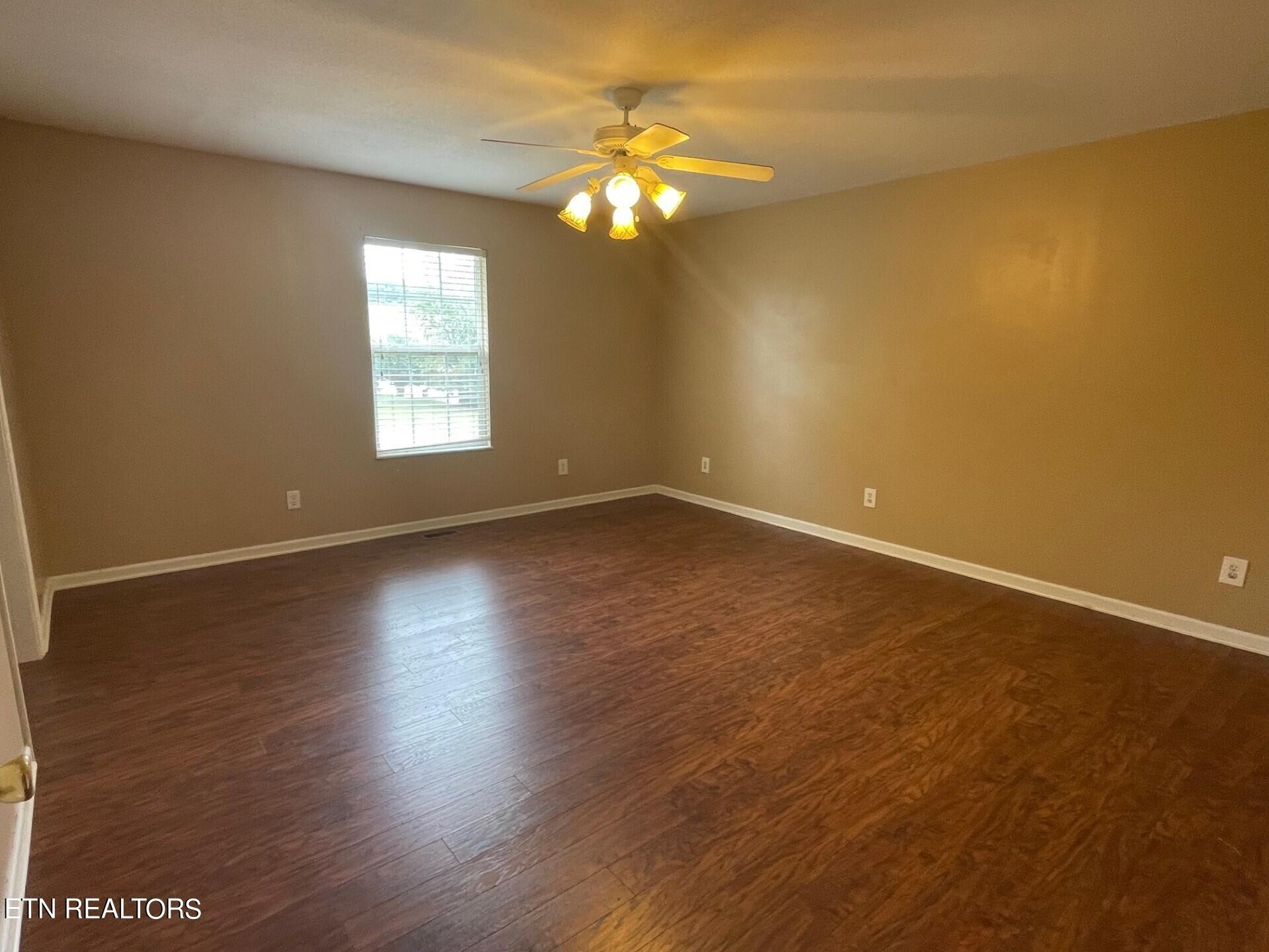5409 Old Niles Ferry Road Maryville, TN 37801 - Photo 18 of 43 an empty room with wooden floor and windows