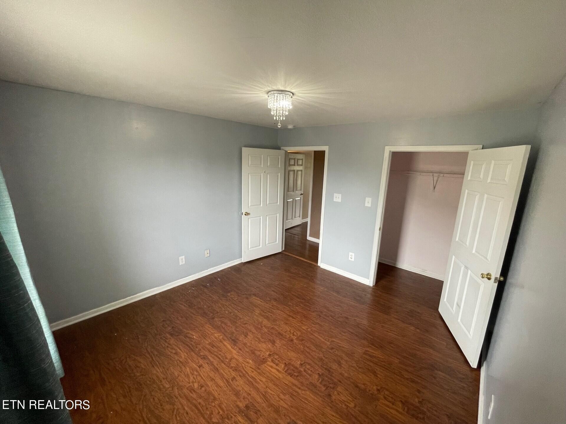 5409 Old Niles Ferry Road Maryville, TN 37801 - Photo 24 of 43 an empty room with wooden floor and windows
