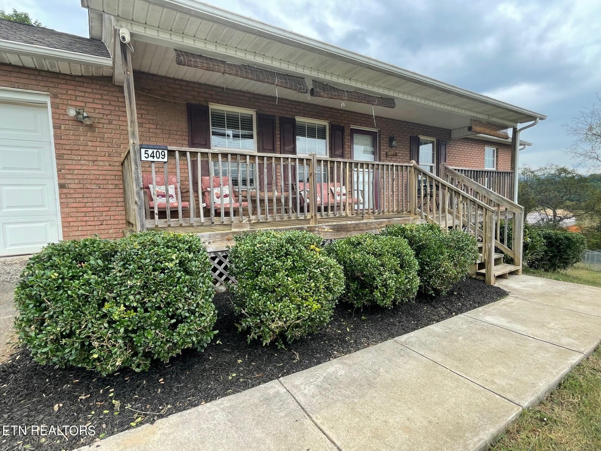 5409 Old Niles Ferry Road Maryville, TN 37801 - Photo 3 of 43 a front view of a house with a lots of flower garden