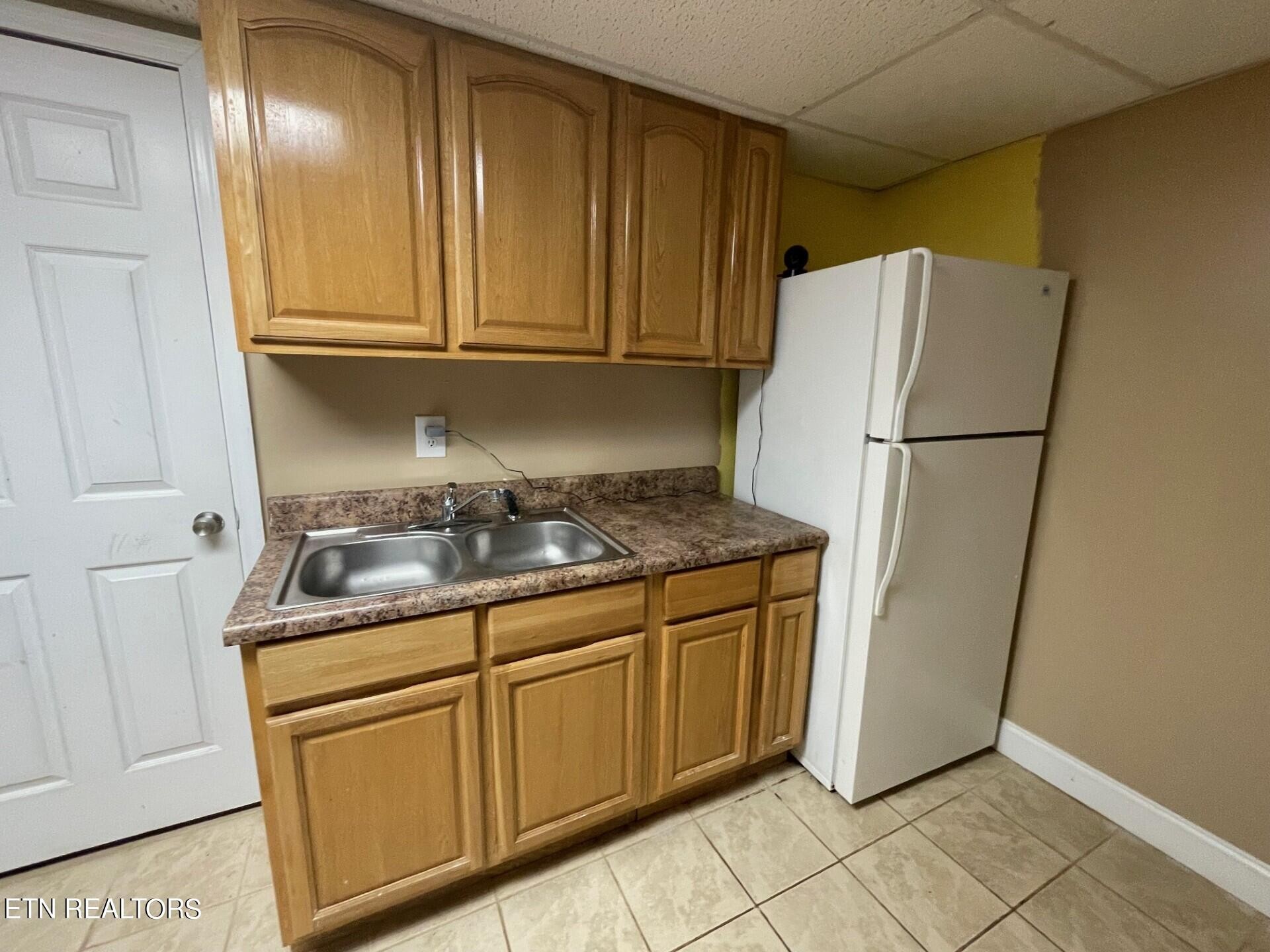 5409 Old Niles Ferry Road Maryville, TN 37801 - Photo 31 of 43 a kitchen with stainless steel appliances granite countertop a refrigerator a stove and white cabinets with wooden floor