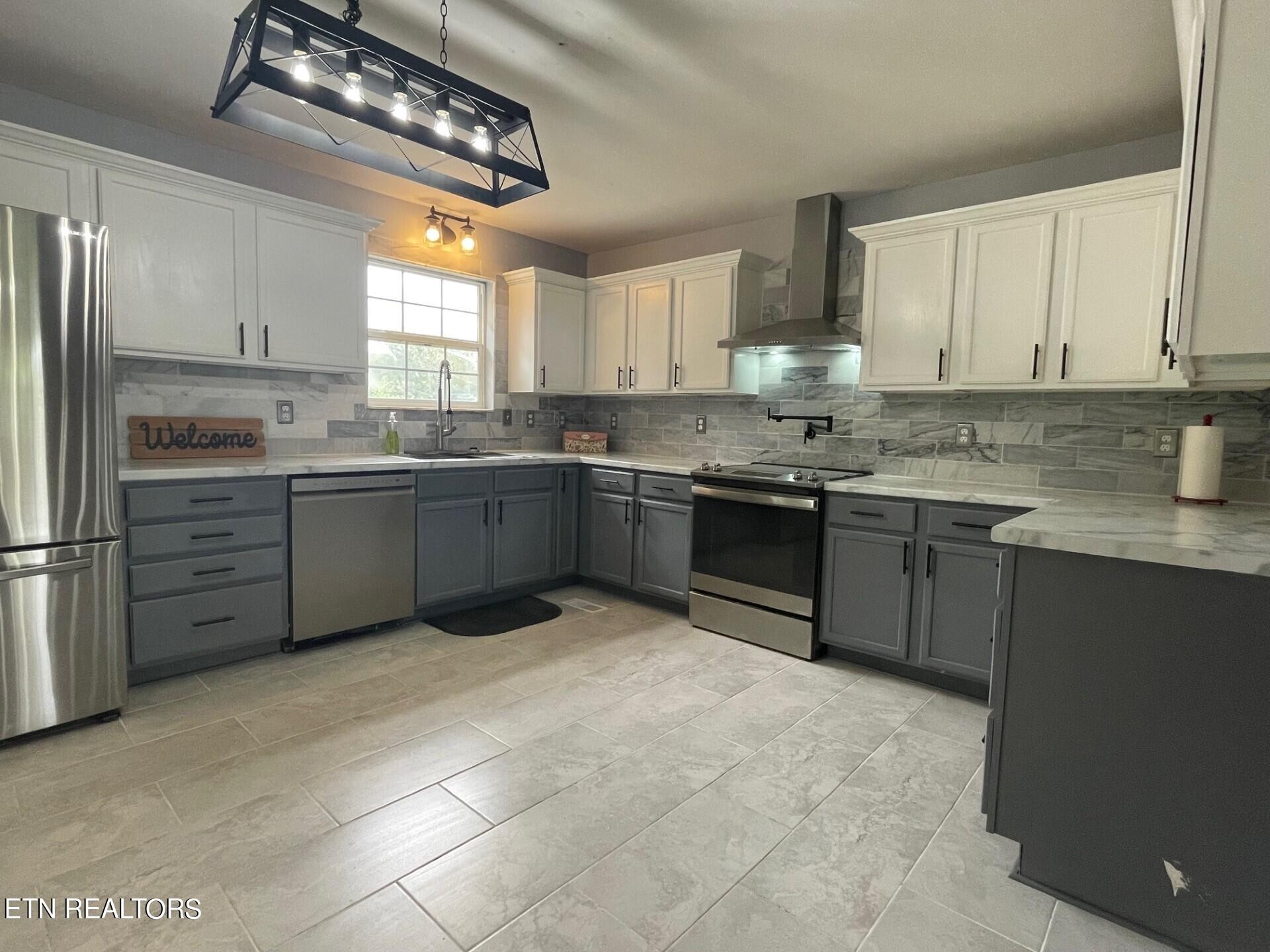5409 Old Niles Ferry Road Maryville, TN 37801 - Photo 10 of 43 a kitchen with stainless steel appliances granite countertop a sink counter space cabinets and a large window