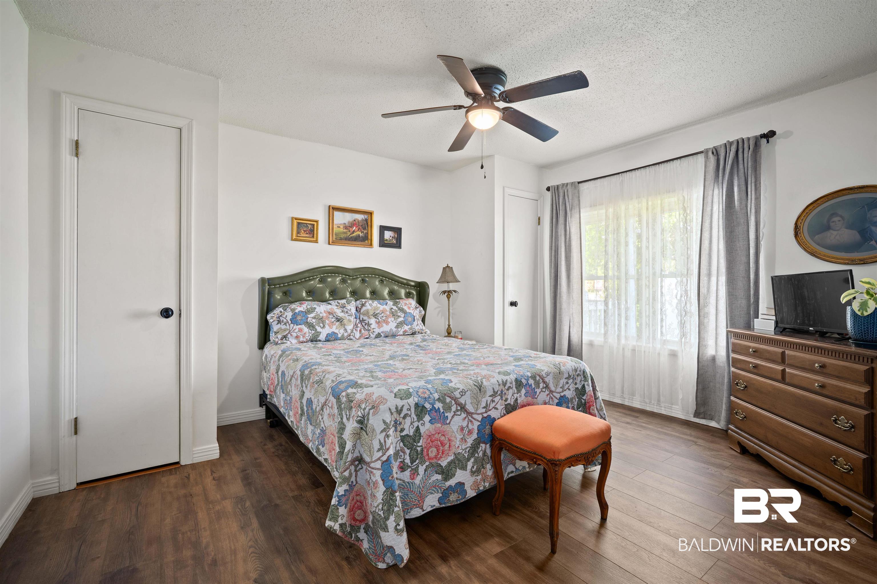 22 Horace Odom Road Millry, AL 36558 - Photo 23 of 39 Bedroom with dark wood-style floors, a textured ceiling, and a ceiling fan