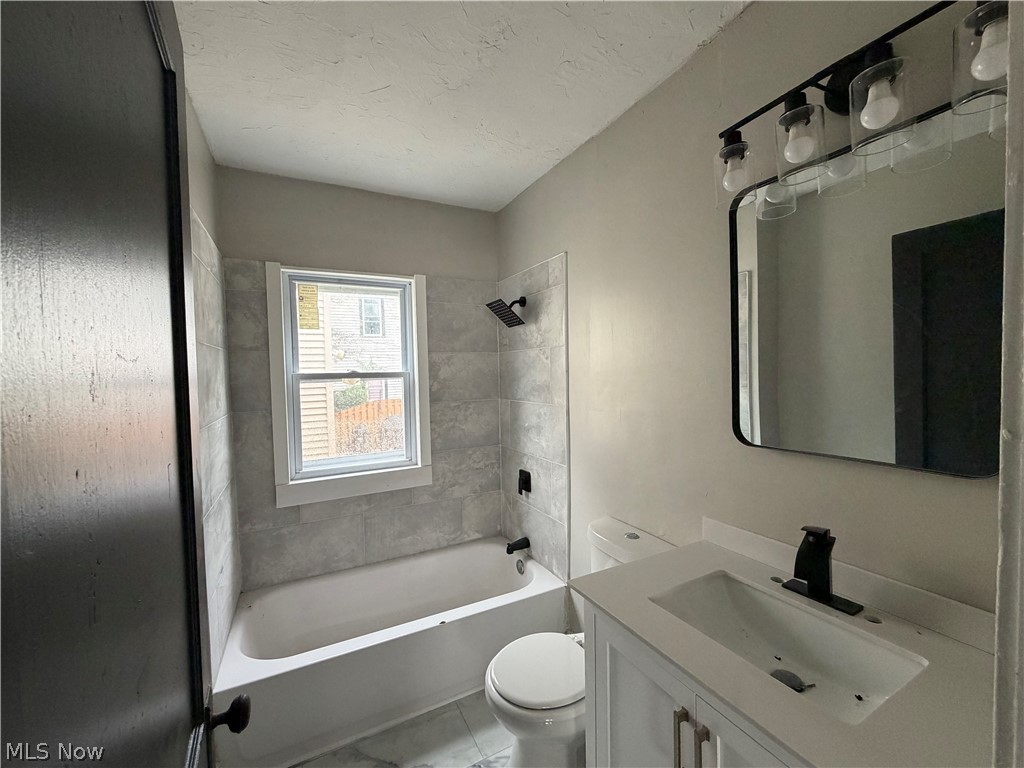 15317 Shiloh Road Cleveland, OH 44110 - Photo 29 of 29 Bathroom featuring a white vanity with a rectangular sink and matte black faucet, a rectangular mirror, and a four-light vanity fixture