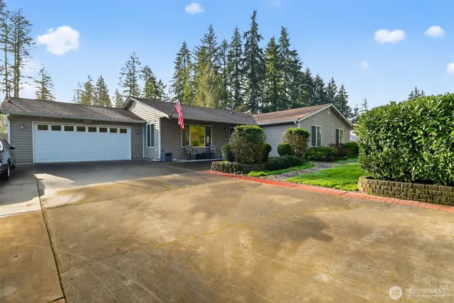 a view of a house with a yard and potted plants