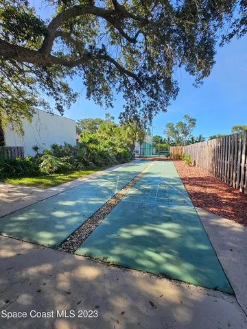 a view of a swimming pool with a bench and some trees