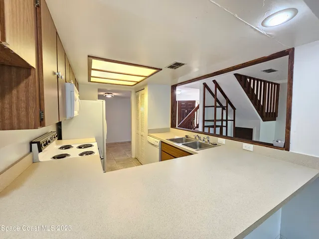 a kitchen with a refrigerator and a stove