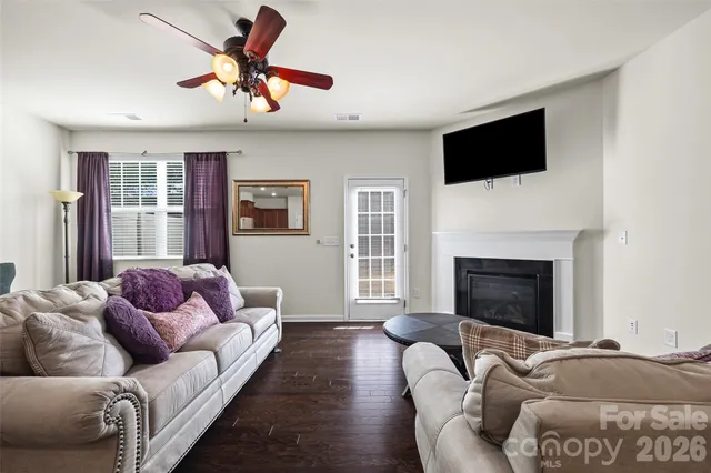 a living room with furniture fireplace and flat screen tv