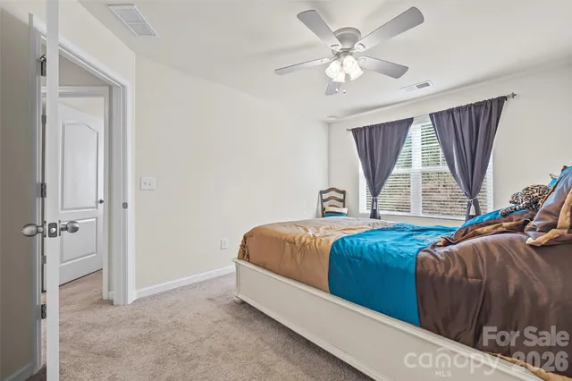 a spacious bedroom with a bed and a window