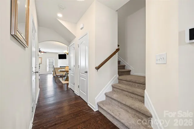 a view of entryway and hall with wooden floor