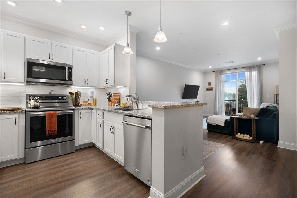 a kitchen with sink a microwave and cabinets