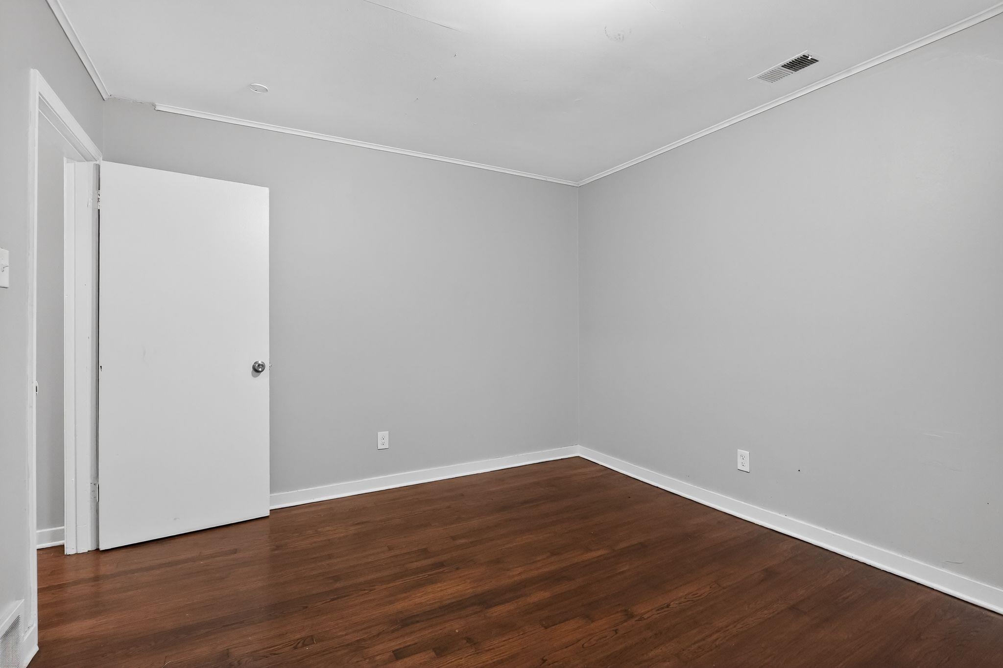 177 East Raines Road Memphis, TN 38109 - Photo 8 of 32 a view of an empty room with wooden floor