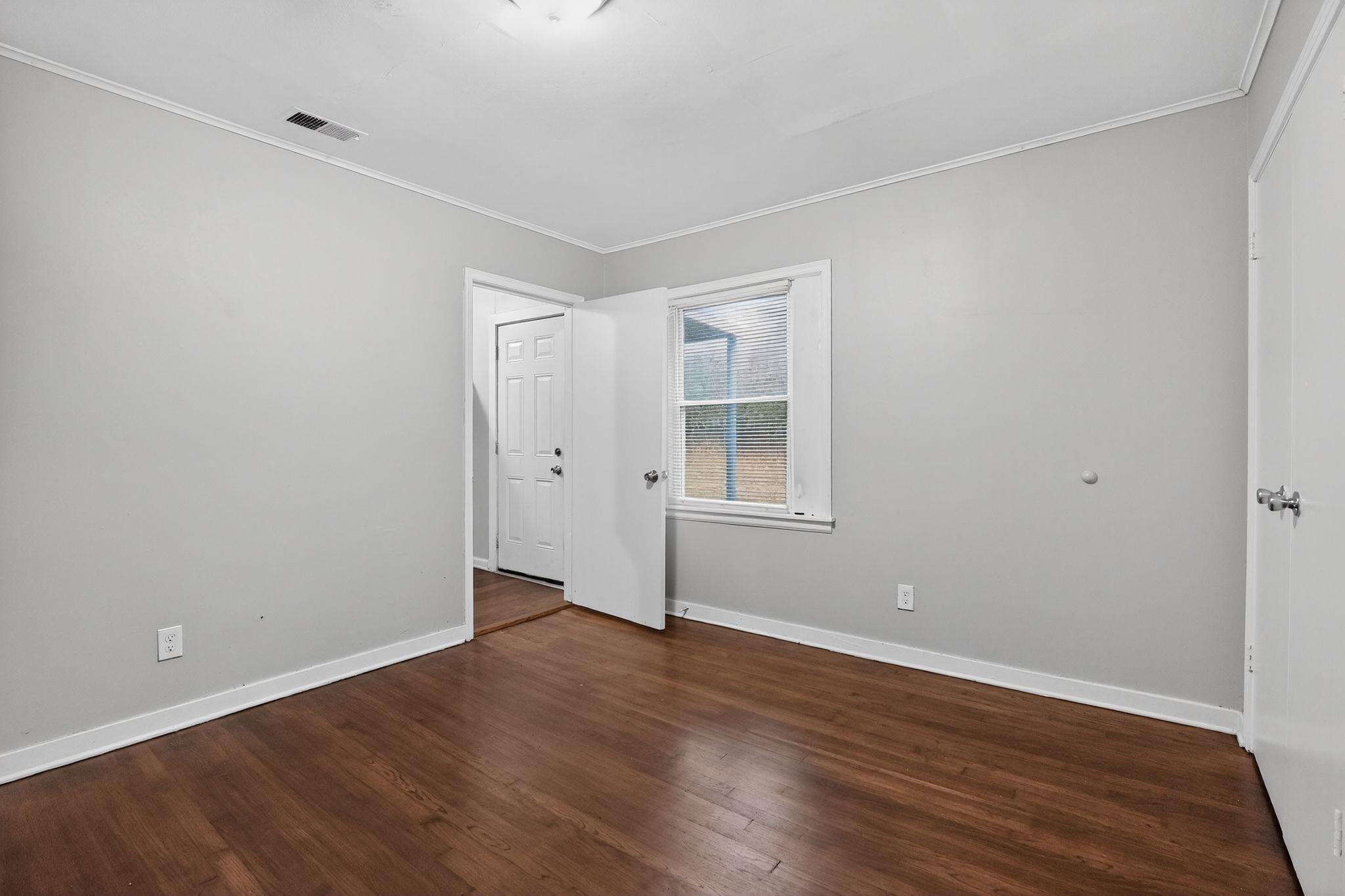 177 East Raines Road Memphis, TN 38109 - Photo 9 of 32 a view of empty room with wooden floor and fan
