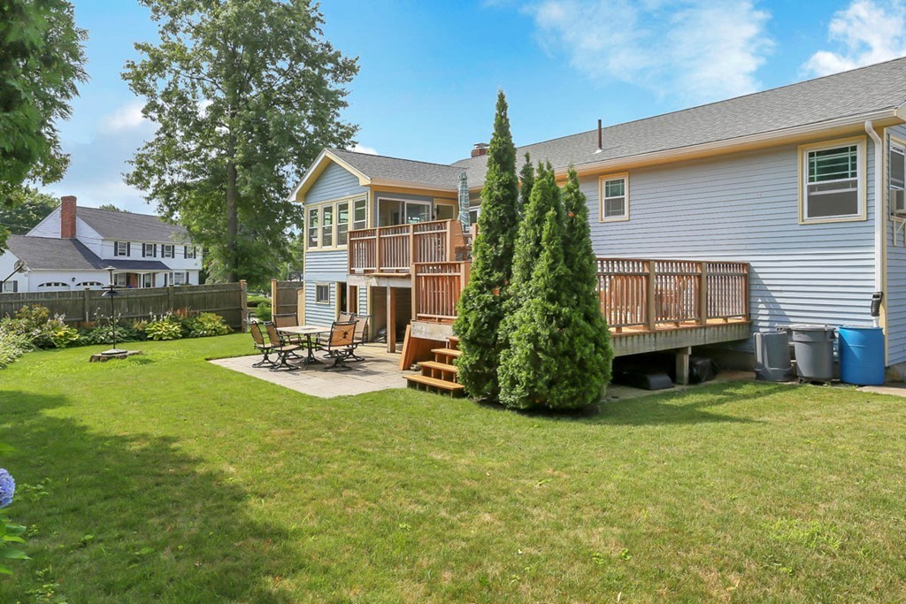 69 Haystack Road Reading, MA 01867 - Photo 27 of 30 a view of a house with backyard sitting area and garden