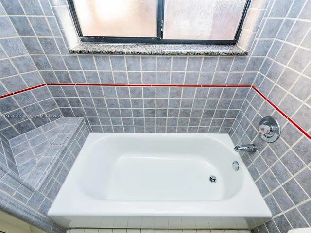 a bathroom with a sink a vanity and a window