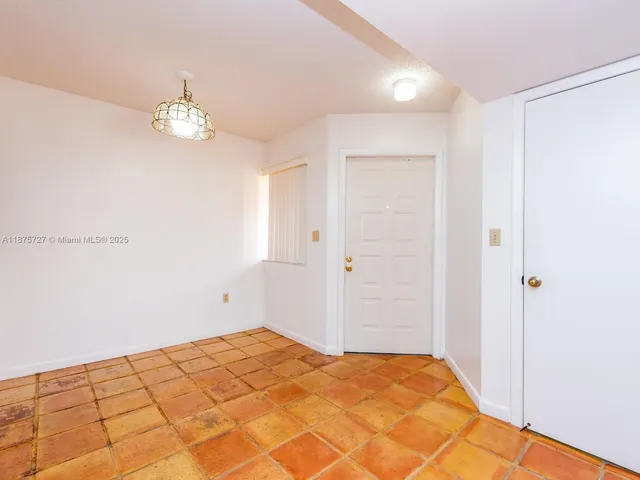 a view of a room with wooden floor and ceiling fan