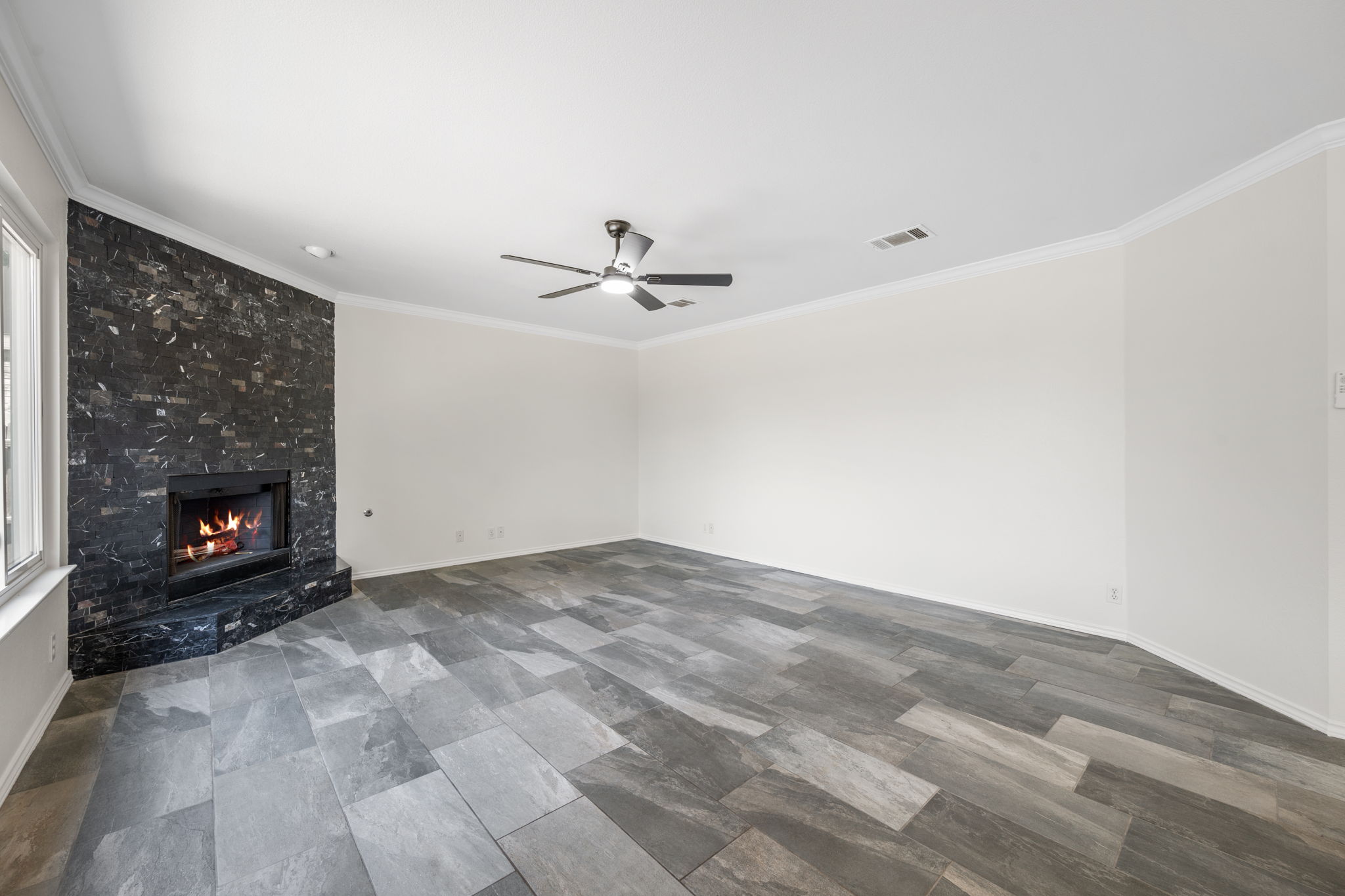 2440 Madeline Loop Cedar Park, TX 78613 - Photo 14 of 33 Unfurnished living room featuring a high end fireplace, crown molding, and ceiling fan