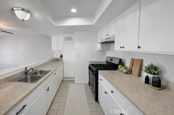 a kitchen that has a sink and a stove
