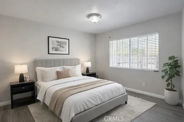 a bedroom with a bed and a potted plant