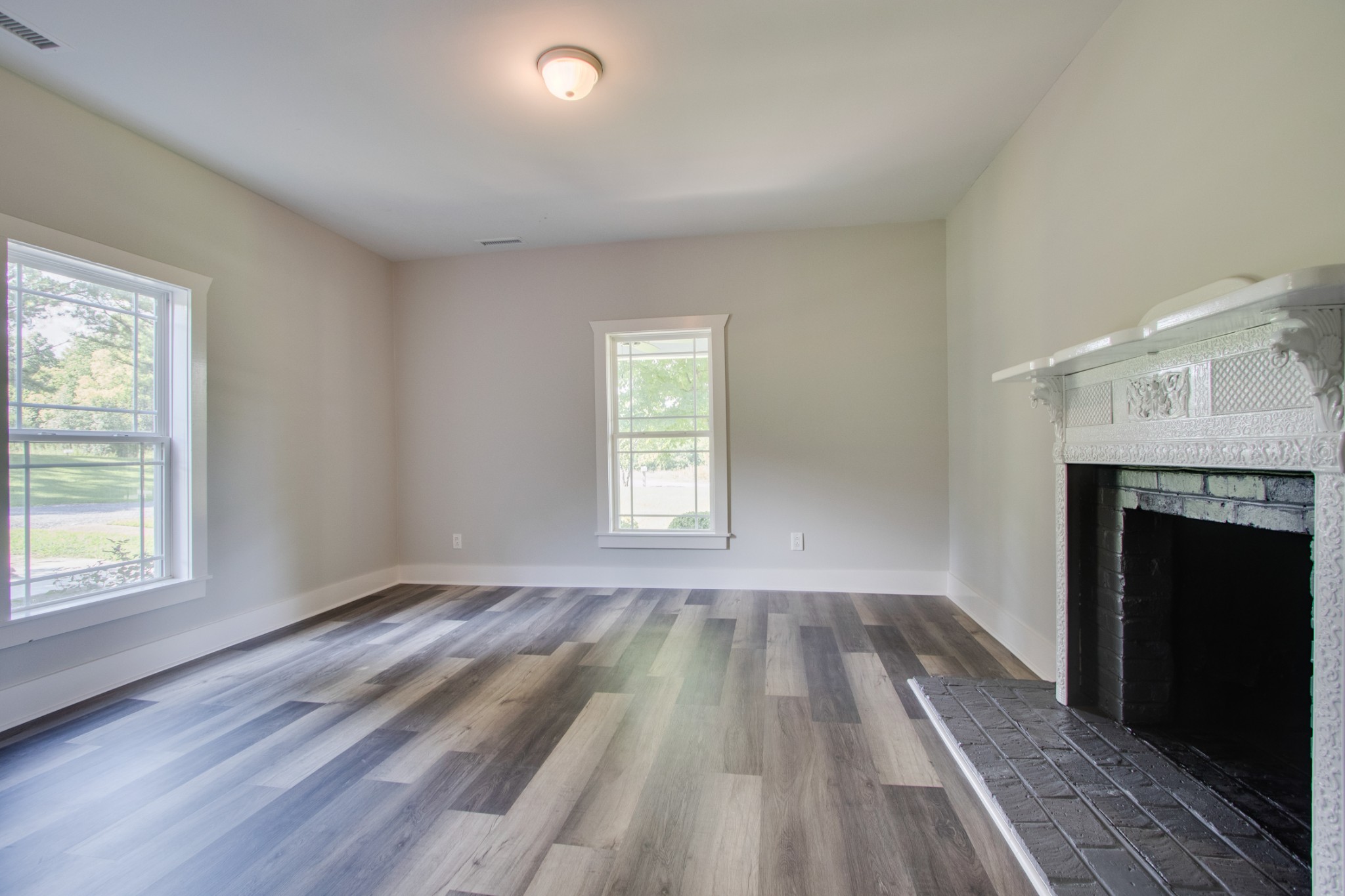 851 Sullivan Bend Road Mount Juliet, TN 37122 - Photo 35 of 50 wooden floor fireplace and windows in an empty room
