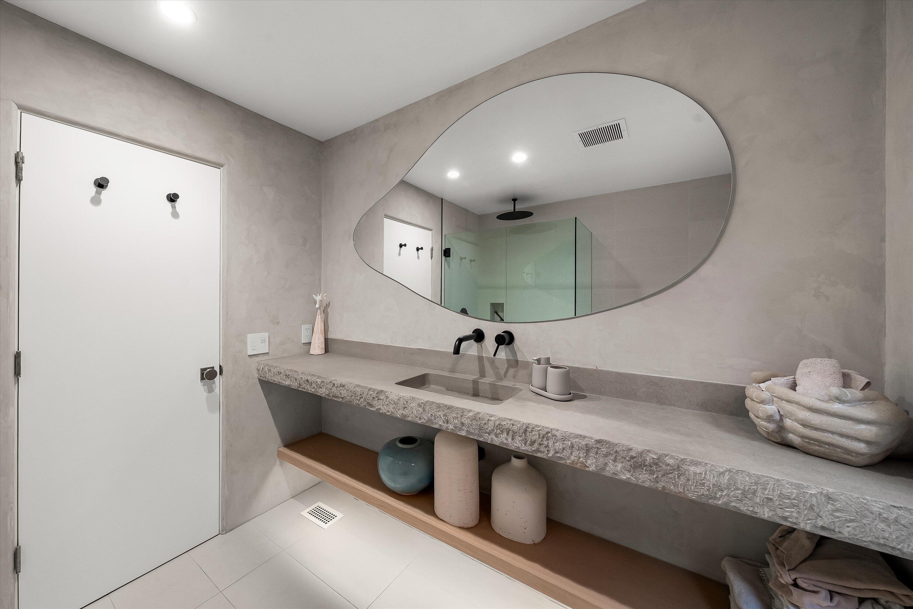 1438 Hillcrest Road Santa Barbara, CA 93103 - Photo 14 of 22 a bathroom with a granite countertop sink a mirror and vanity