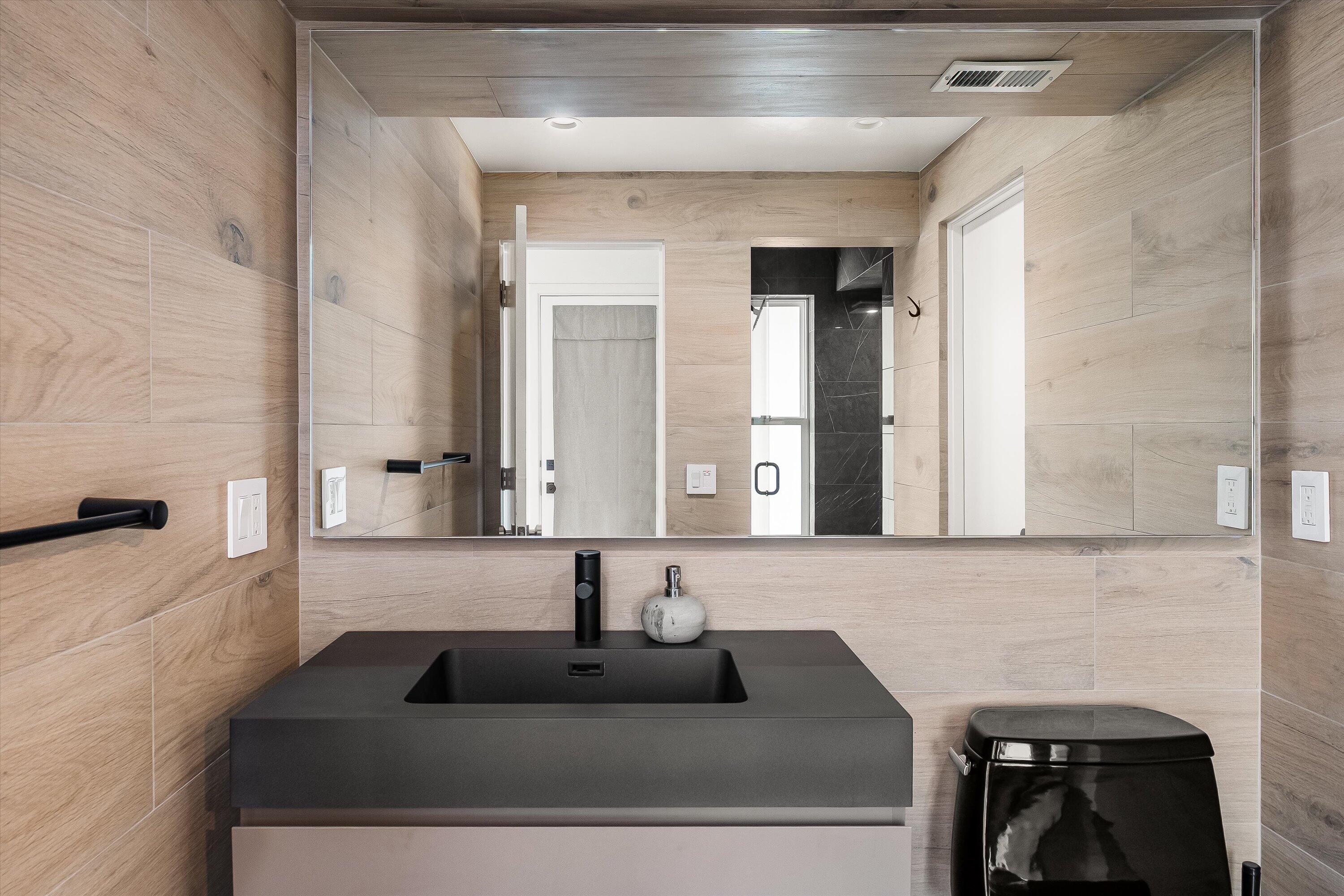1438 Hillcrest Road Santa Barbara, CA 93103 - Photo 15 of 22 a bathroom with a granite countertop sink and a mirror