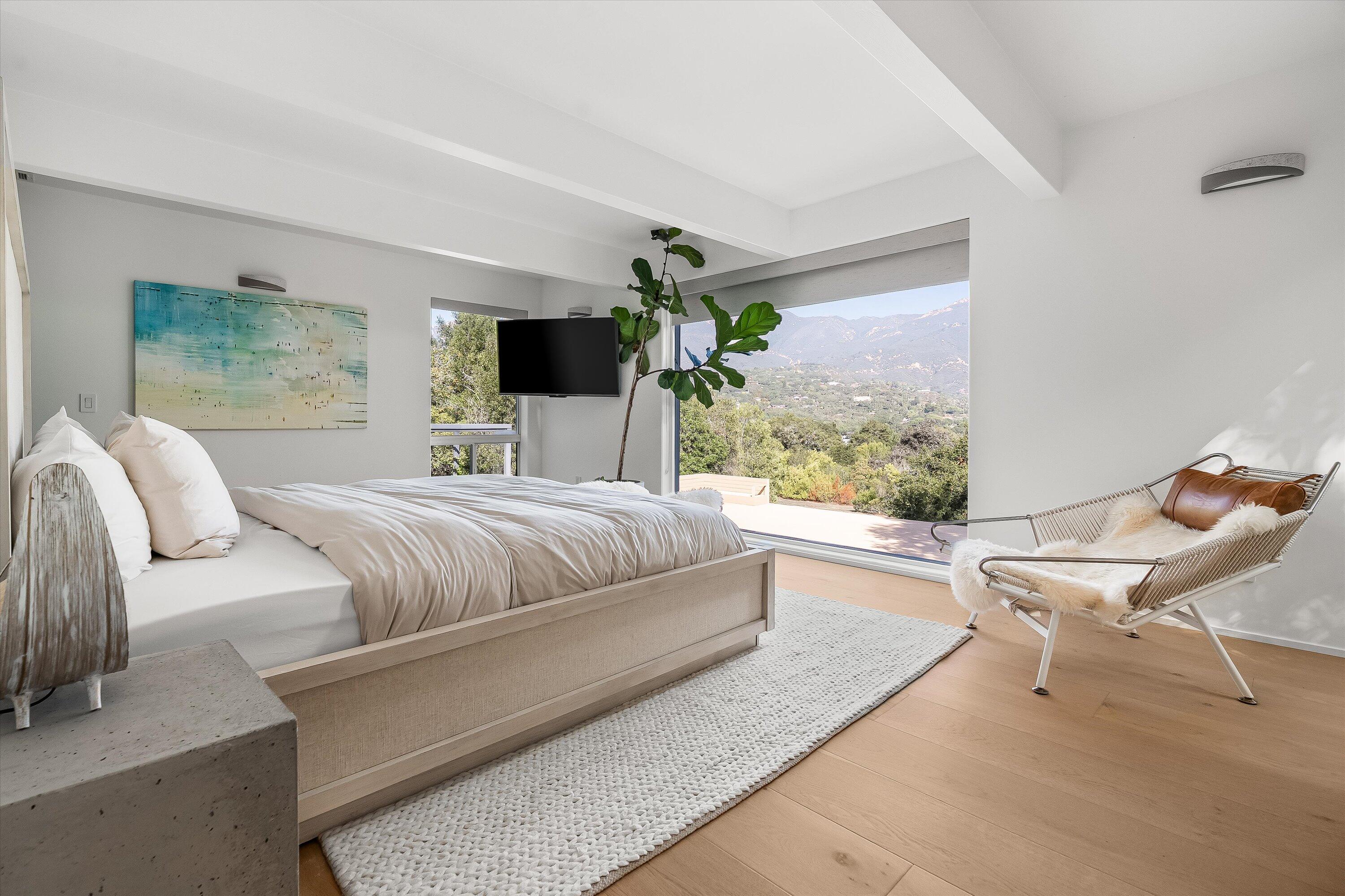 1438 Hillcrest Road Santa Barbara, CA 93103 - Photo 16 of 22 a bedroom with a bed and large windows