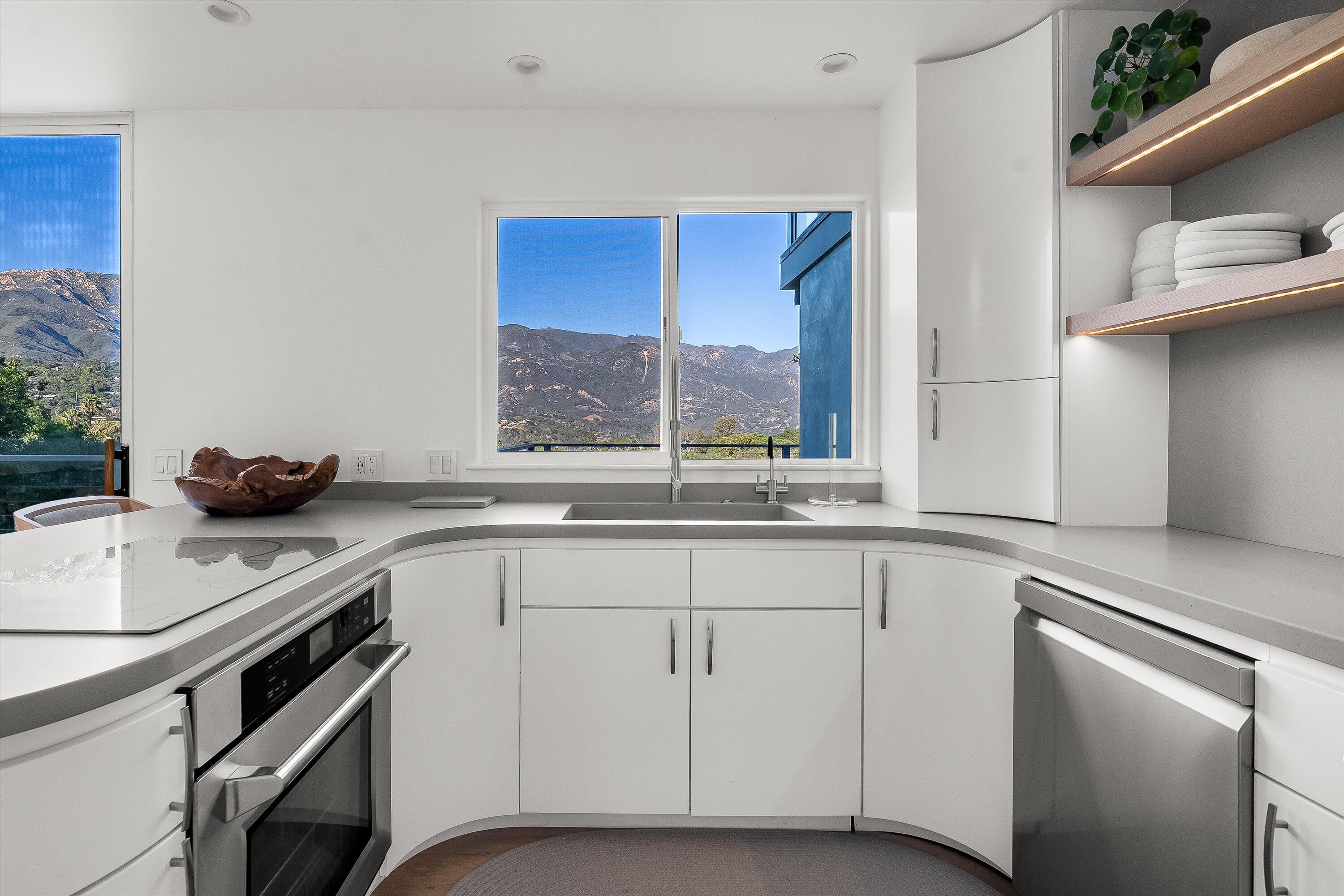 1438 Hillcrest Road Santa Barbara, CA 93103 - Photo 7 of 22 a kitchen with a sink stove and cabinets