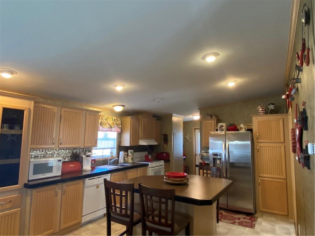 332 Iron Bite Drive Tarrs, PA 15688 - Photo 5 of 19 a kitchen with a dining table cabinets appliances and a counter top space