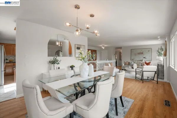 a view of a dining room with furniture and wooden floor