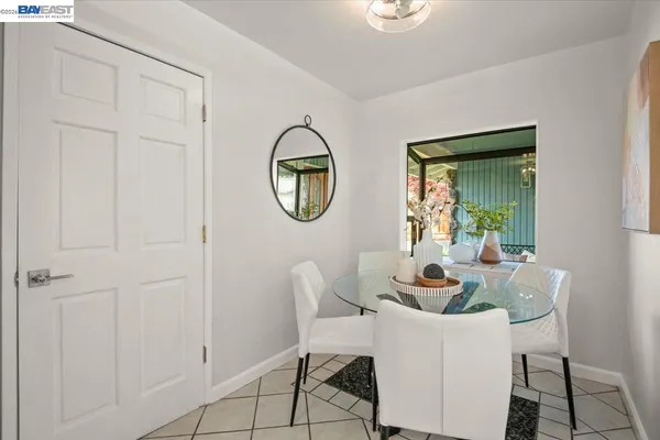 a dining room with furniture a mirror and a window