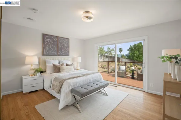 a bedroom with a bed and a large window