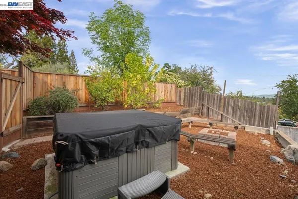 a view of a patio with table and chairs with wooden fence