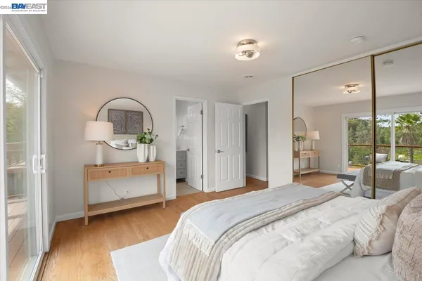 a bedroom with a bed a mirror and a window