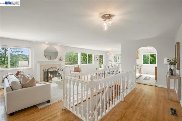 a living room with furniture fireplace and a large window