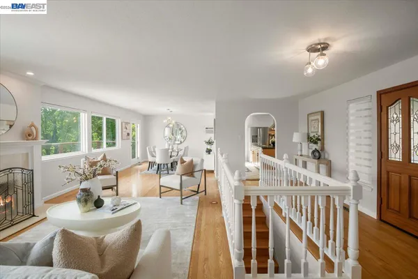 a living room with furniture fireplace and a large window