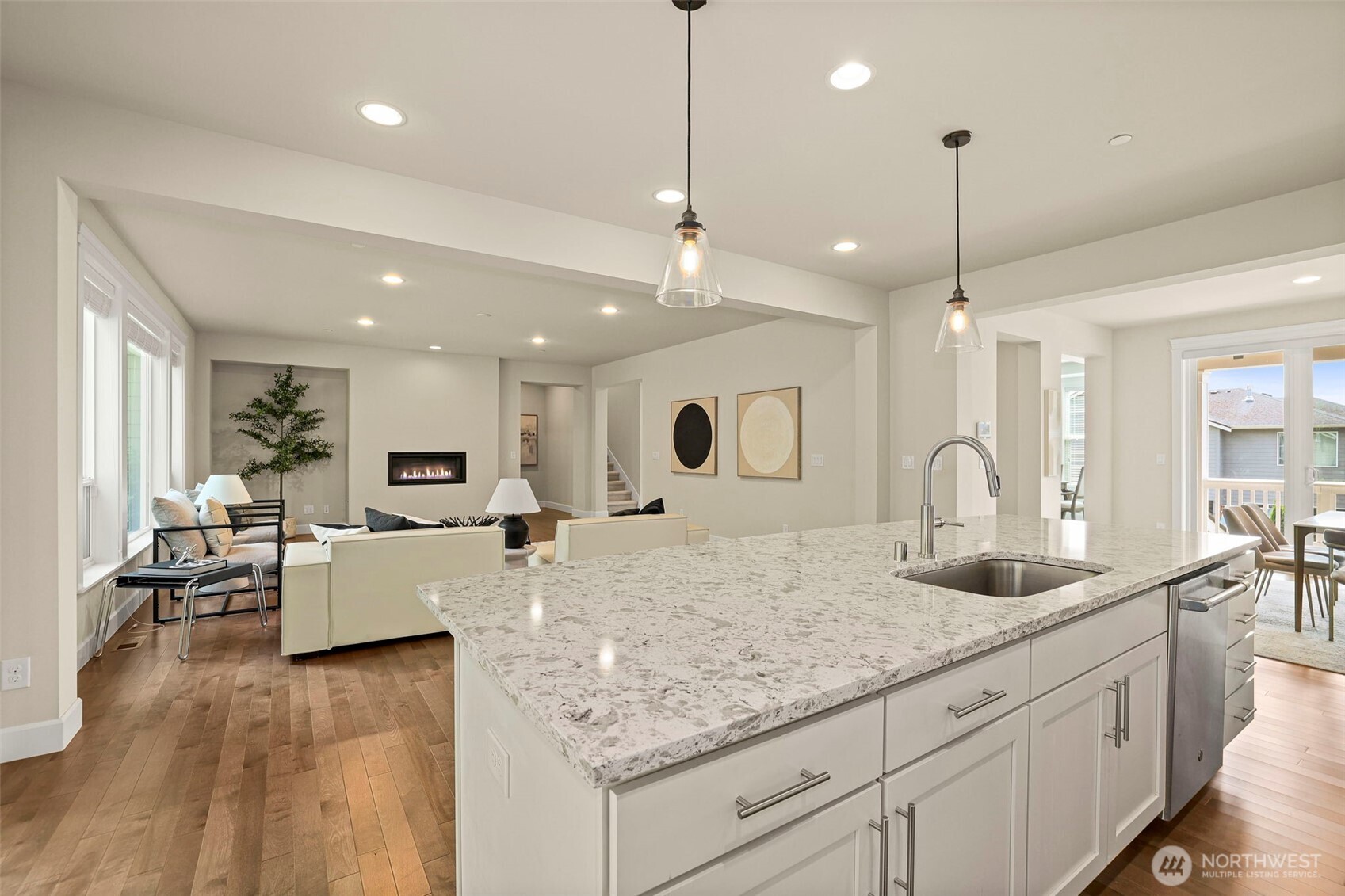 29 242nd Street Southeast Bothell, WA 98021 - Photo 5 of 40 a large kitchen with kitchen island a large counter top a sink appliances and living room view