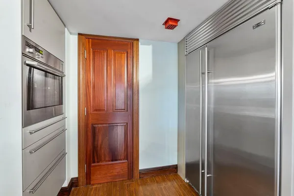 a dining hall with stainless steel appliances kitchen island granite countertop a dining table and chairs