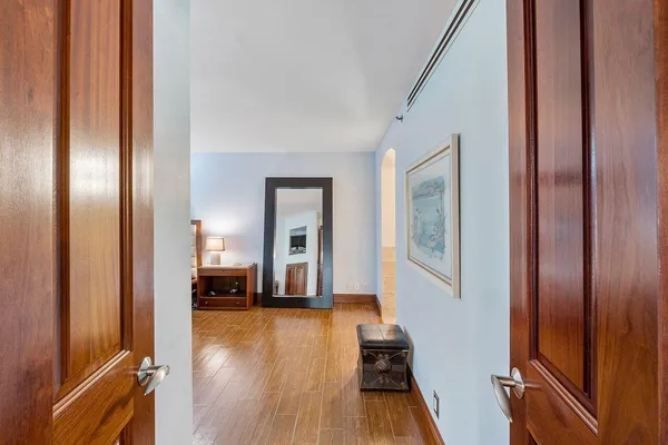 a bedroom with a large bed and a flat tv screen