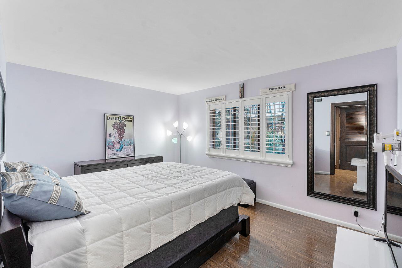 500 Ocean Trail Way, Unit 201 Jupiter, FL 33477 - Photo 30 of 58 a bedroom with a bed and a large window